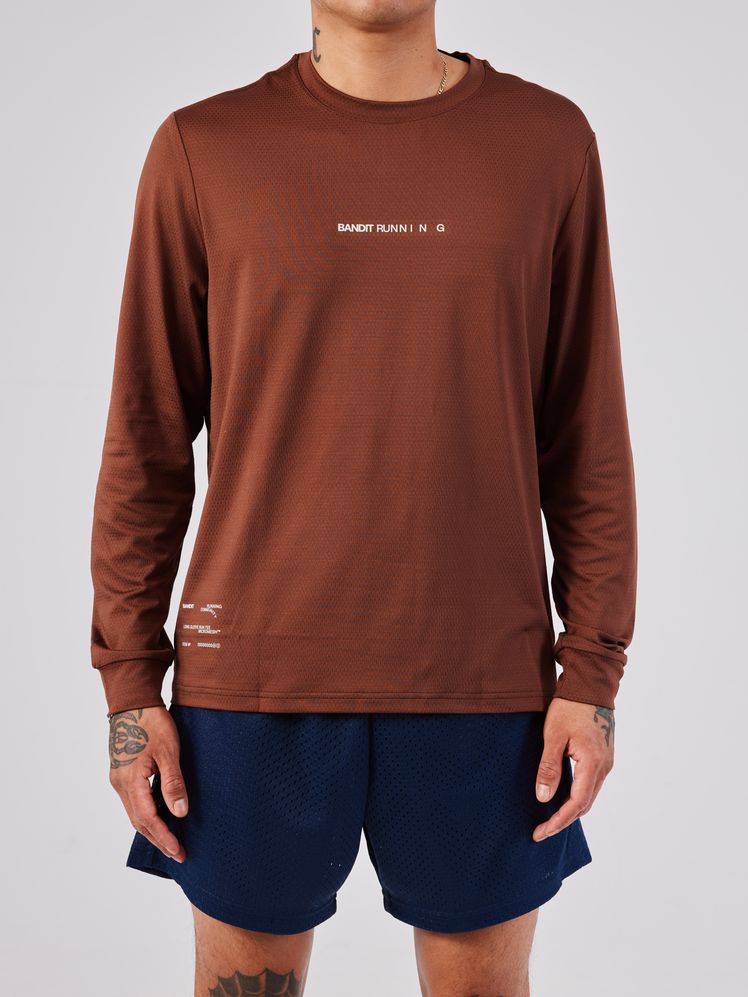 Image may contain: Clothing, Long Sleeve, Sleeve, Shorts, Accessories, Jewelry, Necklace, Adult, and Person