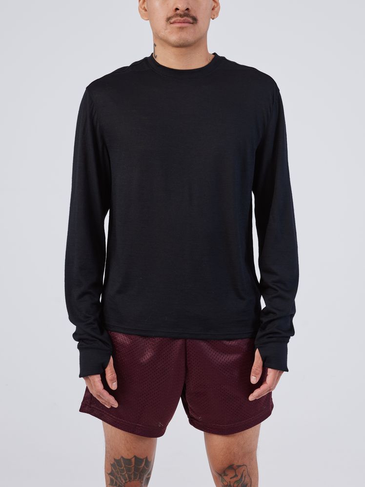 Image may contain: Clothing, Long Sleeve, Sleeve, Adult, Person, Shorts, Knitwear, and Sweater