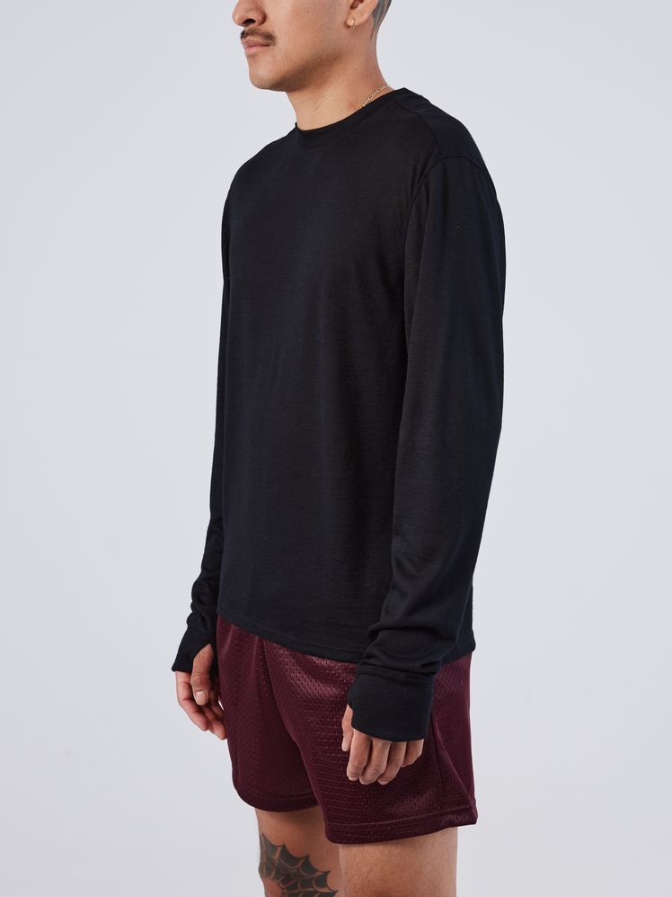 Image may contain: Clothing, Long Sleeve, Sleeve, Adult, Person, Shorts, Accessories, Jewelry, Necklace, and Knitwear