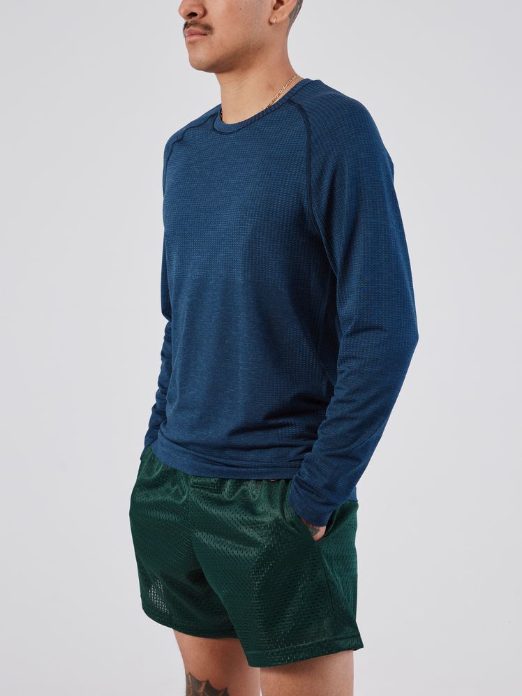 Image may contain: Clothing, Long Sleeve, Sleeve, Shorts, Adult, Person, Knitwear, and Sweater