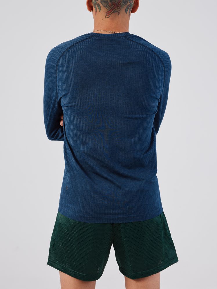 Image may contain: Clothing, Shorts, T-Shirt, Shirt, Long Sleeve, Sleeve, Adult, Person, Accessories, Jewelry, and Necklace