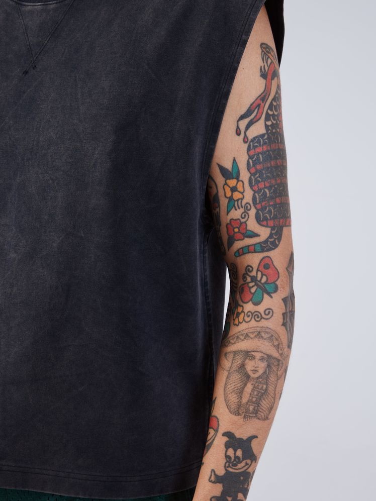 Image may contain: Mae Murray, Person, Skin, Tattoo, Arm, Body Part, Accessories, Jewelry, Necklace, and Adult