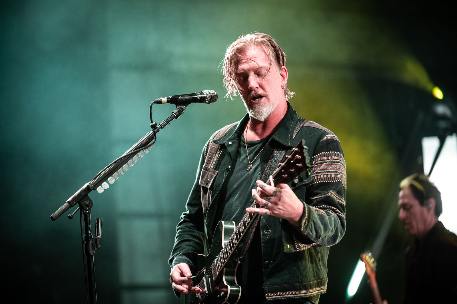 Image may contain Josh Homme Guitar Musical Instrument Electrical Device Microphone Adult Person and Performer