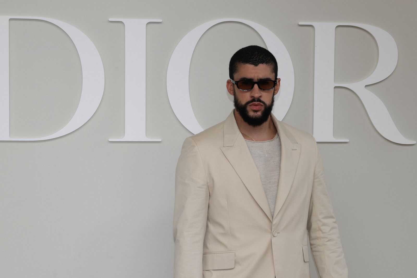 Image may contain Bad Bunny Blazer Clothing Coat Jacket Formal Wear Suit Adult Person Accessories and Sunglasses