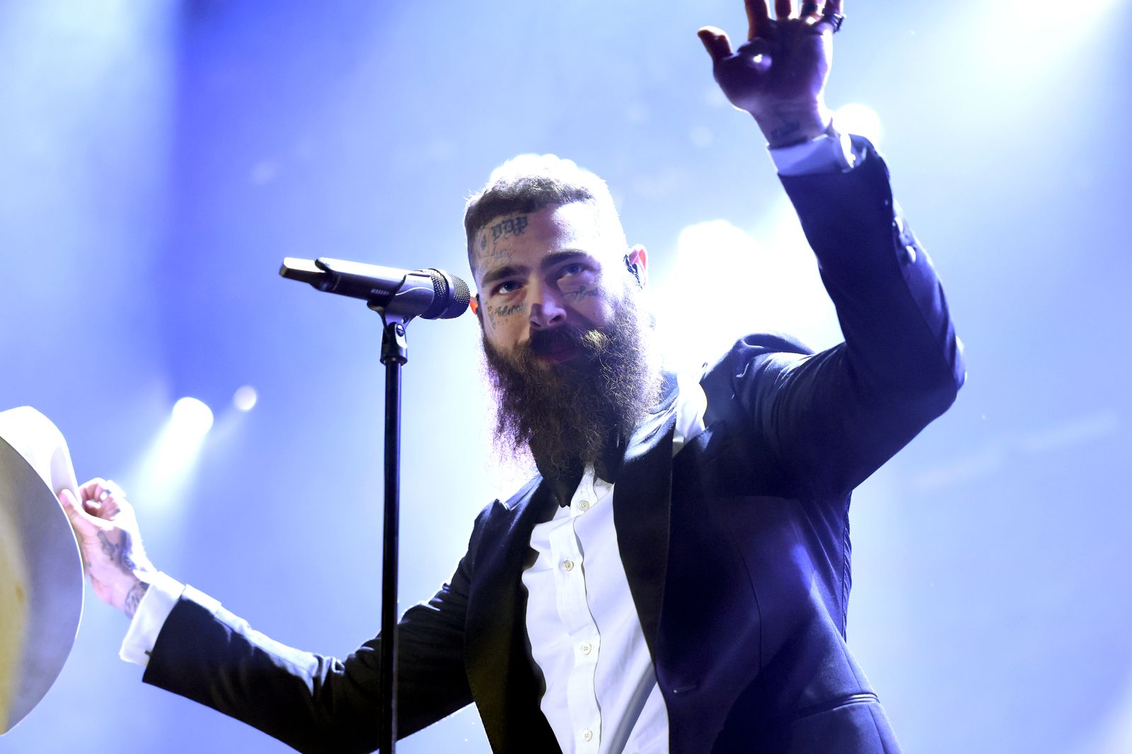 Image may contain Post Malone Performer Person Solo Performance Electrical Device Microphone Adult and Lighting