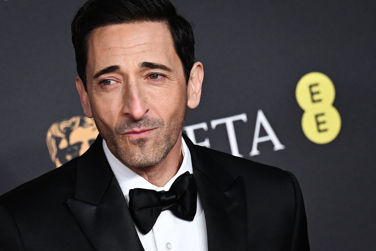 Image may contain Adrien Brody Accessories Formal Wear Tie Clothing Suit Adult Person Face Head and Photography