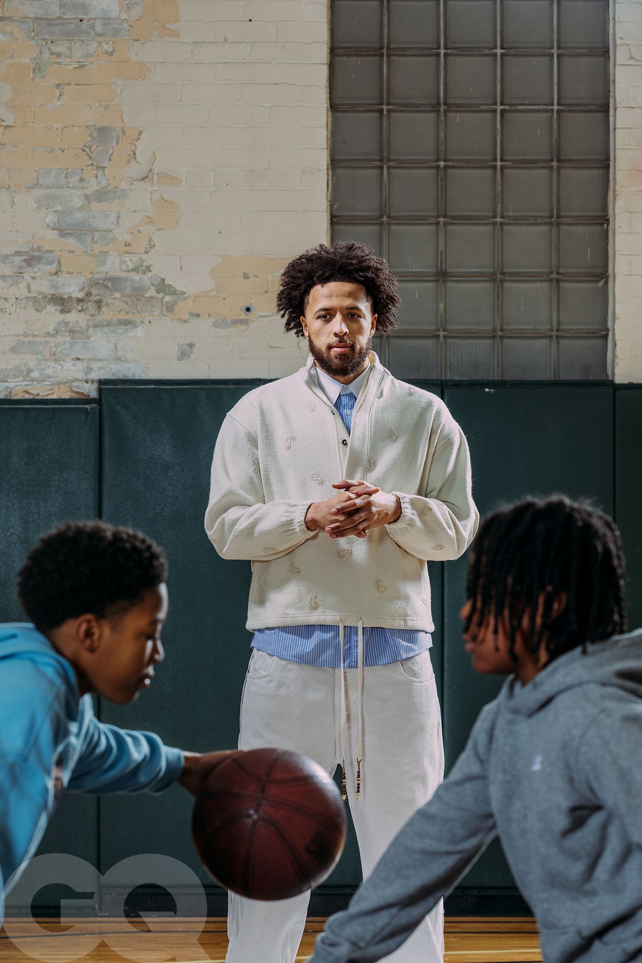 Image may contain Ball Basketball Basketball Sport Adult Person Child Clothing and Coat