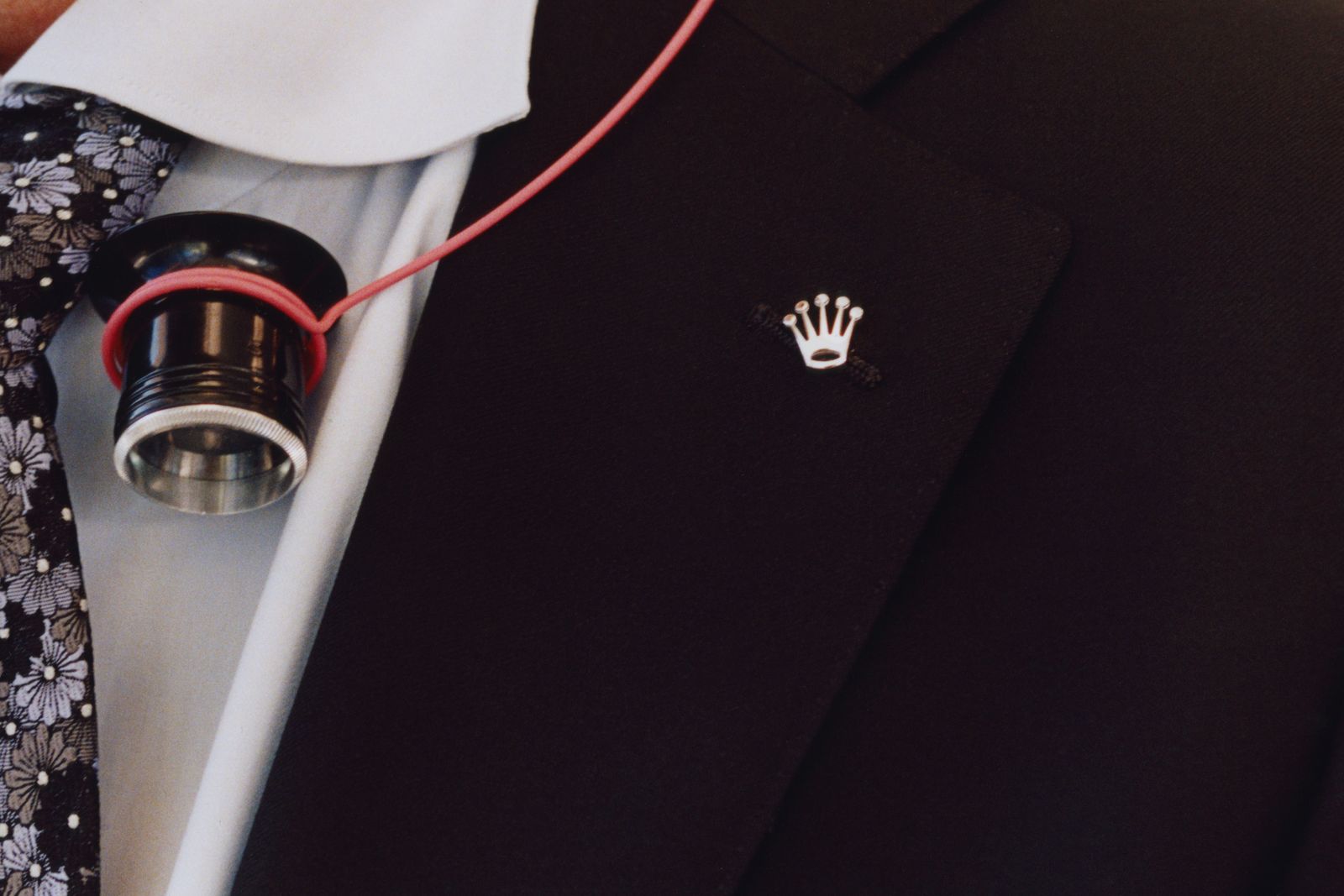 Image may contain Clothing Coat Accessories Formal Wear Tie Suit and Logo