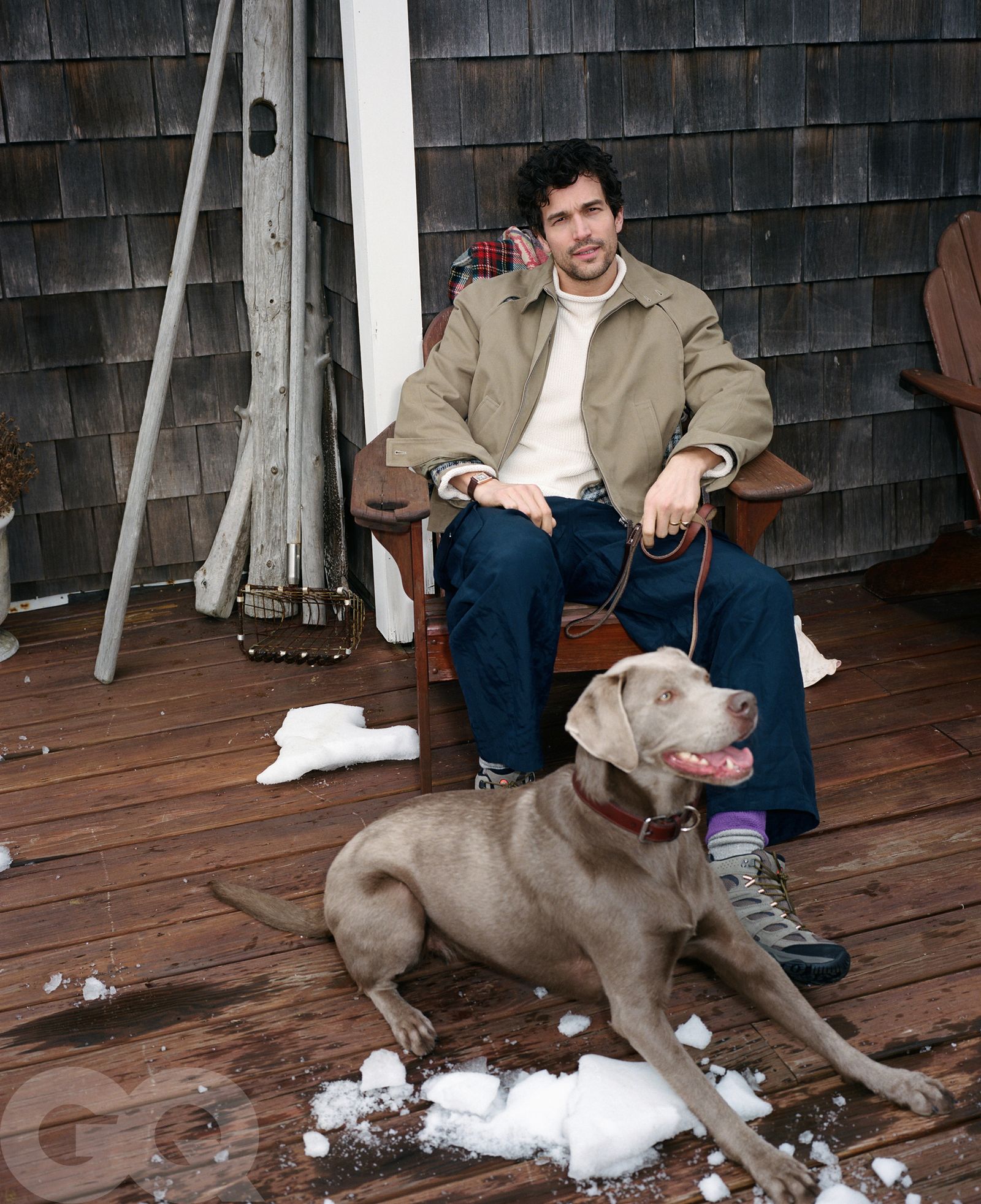 Image may contain Clothing Pants Coat Face Head Person Photography Portrait Sitting Wood Jacket Adult and Animal