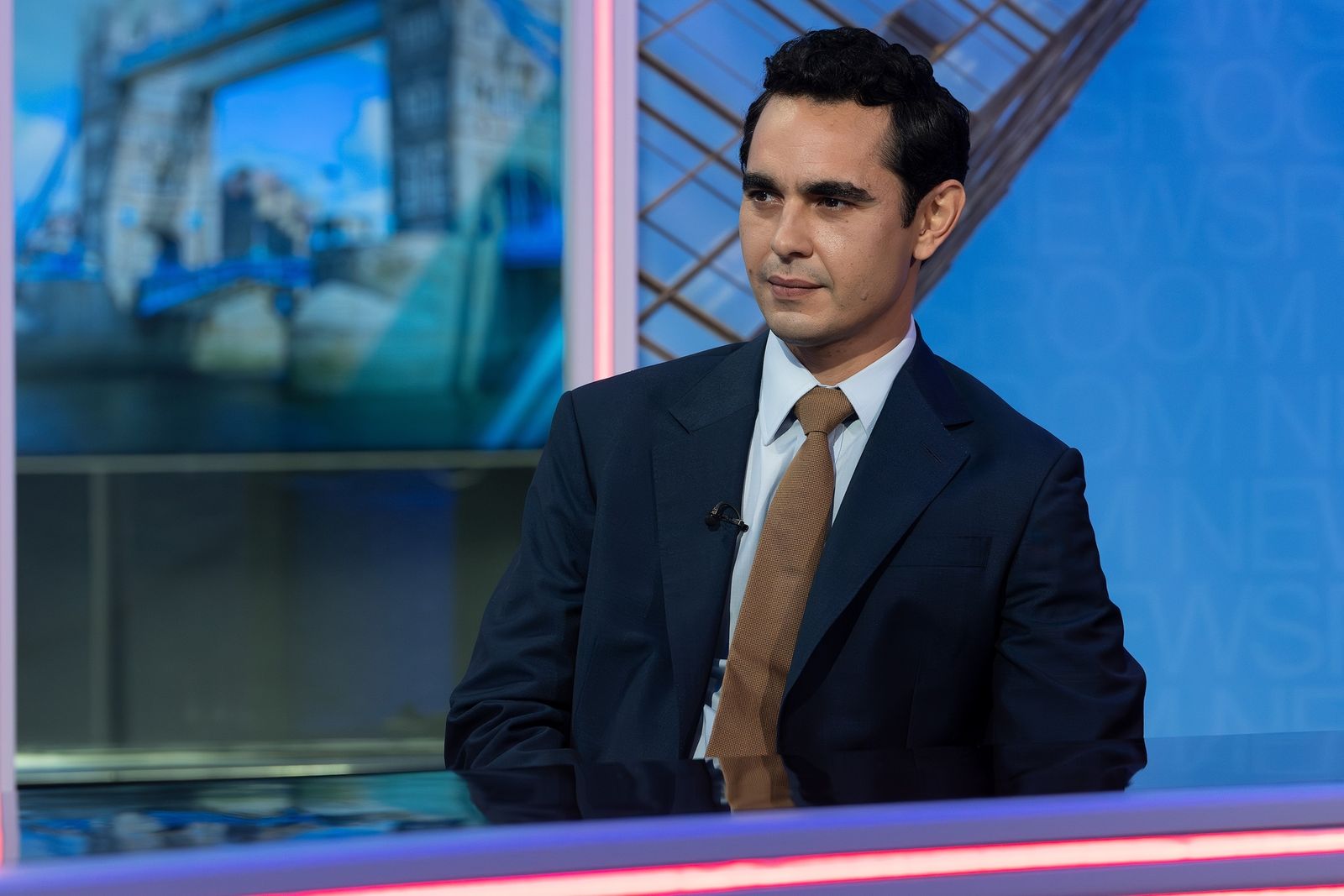 Image may contain Max Minghella Black Hair Hair Person Formal Wear Adult Blazer Clothing Coat and Jacket