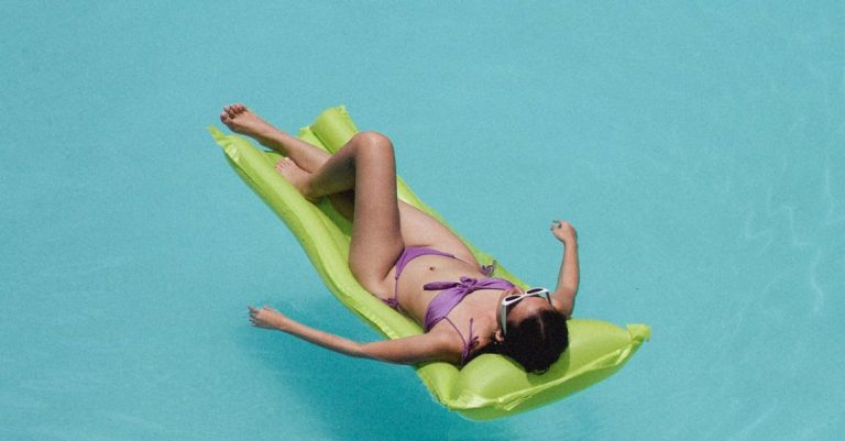 Beachwear - Relaxed woman lying on air mattress