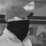 Outerwear - A man wearing a face mask and a hat