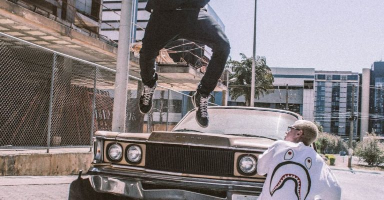 Streetwear - Man Jumping on Front of Brown Car